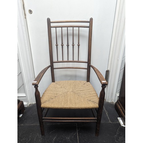 492 - An early 20th century Arts and Crafts oak rush seat side Chair, in the manner of Liberty, spindle ba... 