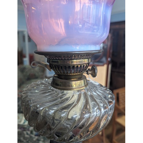 506 - A late 19thC Oil Lamp, with cranberry glass shade, raised on art nouveau style metal base, Rd No. 42... 