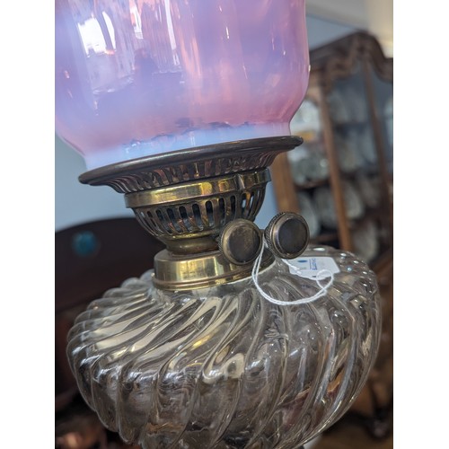 506 - A late 19thC Oil Lamp, with cranberry glass shade, raised on art nouveau style metal base, Rd No. 42... 