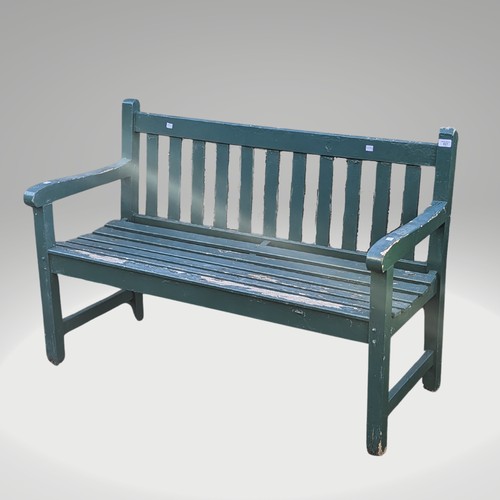 527 - A weathered green painted wooden garden Bench, W 122 cm x H 84 cm x D 57 cm.