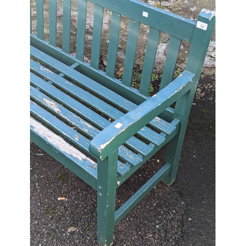 527 - A weathered green painted wooden garden Bench, W 122 cm x H 84 cm x D 57 cm.