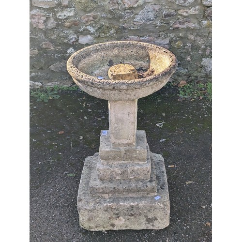 529 - A weathered reconstituted stone Birdbath, raised on plinth base, W 41 cm x H 58 cm x D 41 cm.... 