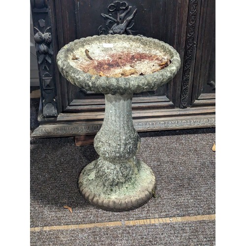 536 - A weathered reconstituted stone Bird Bath, on turned column and plinth base, crack to dish, W 42 cm ... 