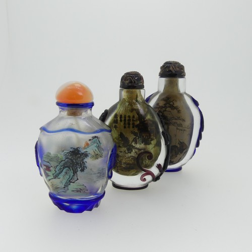 99 - A Chinese interior painted and overlayed glass Snuff Bottle, with interior scene of villagers enclos... 