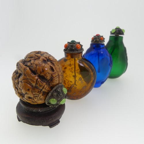 109 - A Chinese 'Luohan' carved walnut shell Snuff Bottle, depicting faces, with metal and stone stopper, ... 