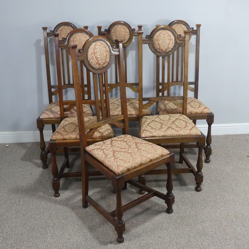 318 - A Set of Six Arts and Crafts oak Dining Chairs, the top rails with upholstered headrests, stick back... 