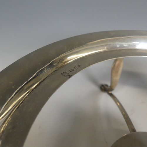 76 - A George V silver Stand and Burner, hallmarked London 1935, of plain circular form raised on four pa... 