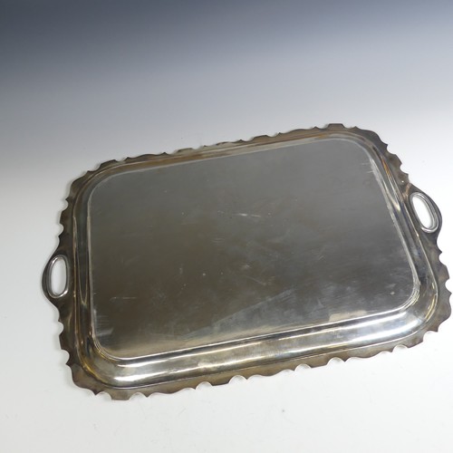 120 - A George V rectangular silver two handled Tray, with plain centre, the shaped rim with cut out oval ... 