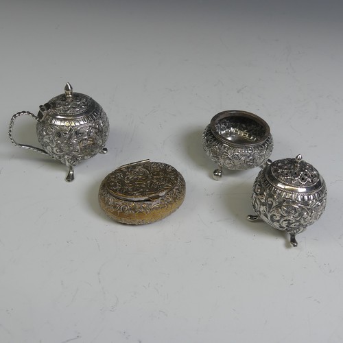 133 - An Indian silver three piece Cruet Set, of circular form with foliate decoration, the mustard with h... 