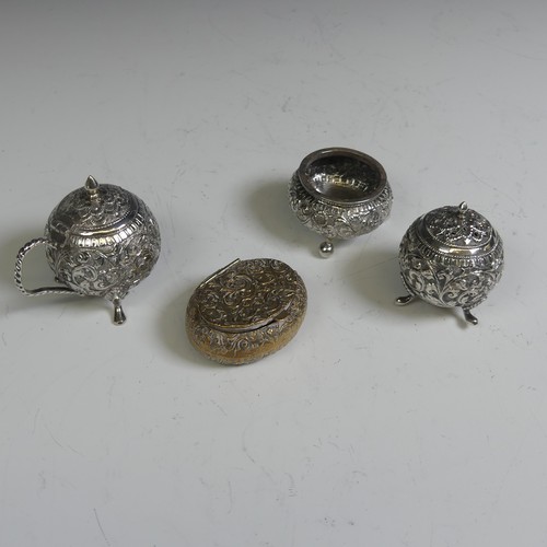 133 - An Indian silver three piece Cruet Set, of circular form with foliate decoration, the mustard with h... 