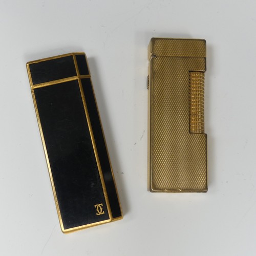 cartier cigarette lighter A Cartier gold plated black enamel Cigarette Lighter, the base marked ' Cartier Paris 1A51651', 7cm h
