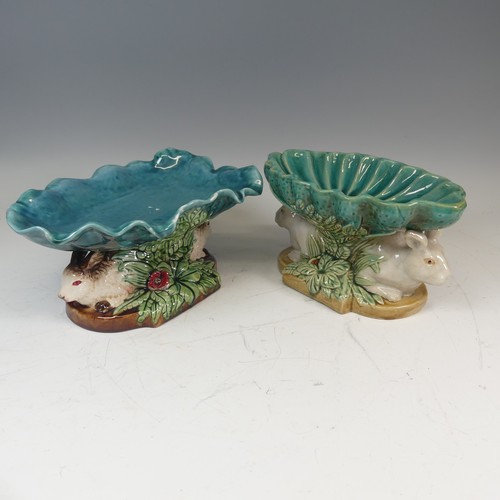 109 - A 19thC style Continental majolica Centrepiece, the leaf shaped dish resting upon two rabbits' bodie... 