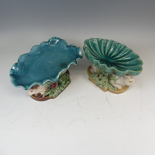 109 - A 19thC style Continental majolica Centrepiece, the leaf shaped dish resting upon two rabbits' bodie... 