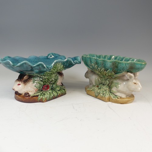 109 - A 19thC style Continental majolica Centrepiece, the leaf shaped dish resting upon two rabbits' bodie... 