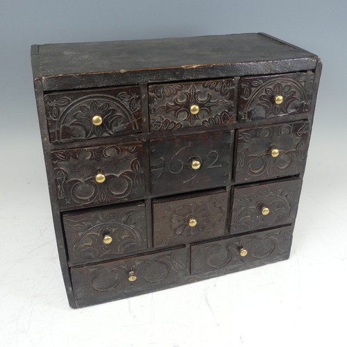 422 - An 18th century elm spice Chest, carved with stylised foliate work and dated '1692', W 39.5 cm x H 3... 