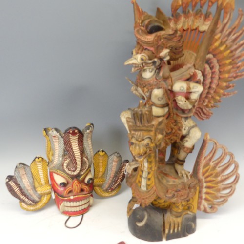 632 - A large Vintage carved polychrome figure of Garuda, H 76.5 cm, together with a painted carved Tribal... 