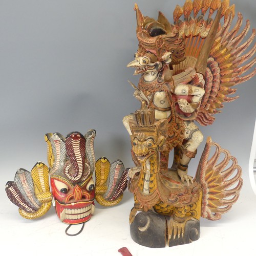 632 - A large Vintage carved polychrome figure of Garuda, H 76.5 cm, together with a painted carved Tribal... 