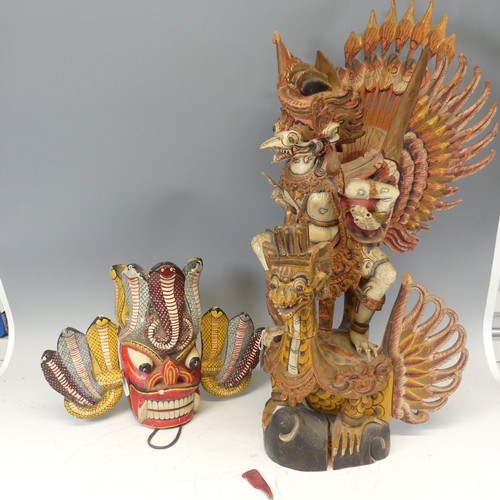 632 - A large Vintage carved polychrome figure of Garuda, H 76.5 cm, together with a painted carved Tribal... 