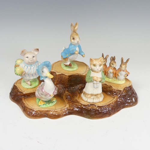 112 - A large collection of Beswick Beatrix Potter Figures, to comprise Pig-Wig, Sally Henny Penny, Anna M... 