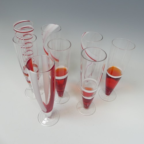 125 - A set of eight modern Flutes by Guzzini, of stylish design, each one decorated with reds and whites ... 