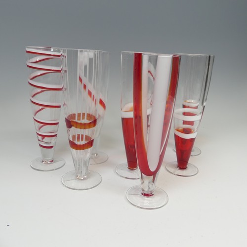 125 - A set of eight modern Flutes by Guzzini, of stylish design, each one decorated with reds and whites ... 