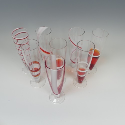 125 - A set of eight modern Flutes by Guzzini, of stylish design, each one decorated with reds and whites ... 