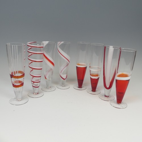 125 - A set of eight modern Flutes by Guzzini, of stylish design, each one decorated with reds and whites ... 