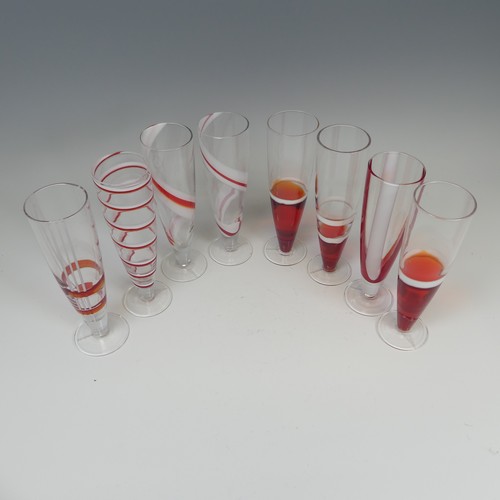 125 - A set of eight modern Flutes by Guzzini, of stylish design, each one decorated with reds and whites ... 