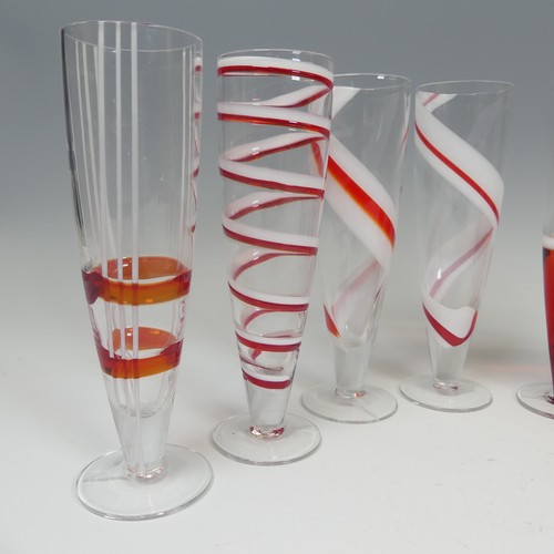 125 - A set of eight modern Flutes by Guzzini, of stylish design, each one decorated with reds and whites ... 