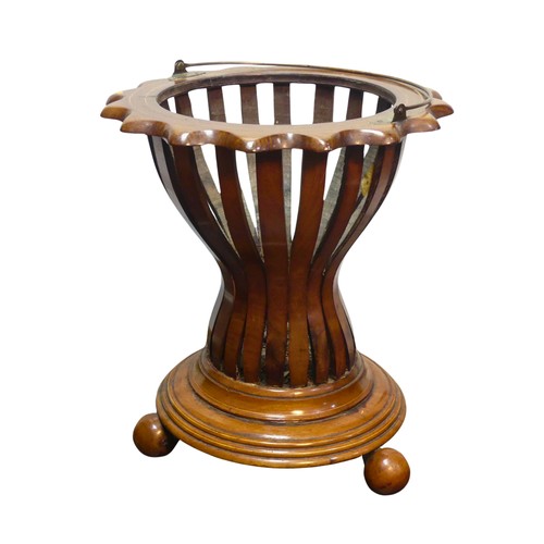 349 - An Edwardian mahogany Regency inspired Planter, with slatted circular base, raised on four rounded f... 