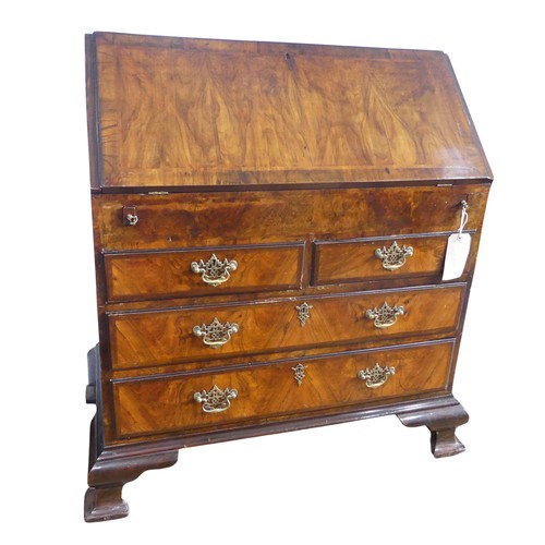 351 - A small Georgian mahogany Bureau, sloped fall front concealing fitted interior with ; pigeon holes, ... 