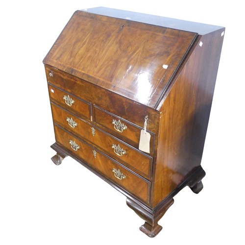 351 - A small Georgian mahogany Bureau, sloped fall front concealing fitted interior with ; pigeon holes, ... 