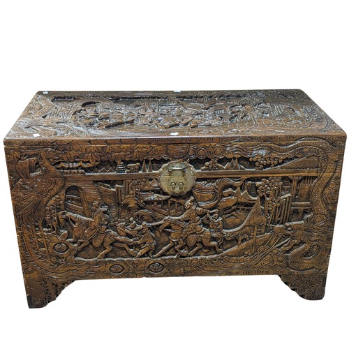 356 - A heavily Chinese carved camphorwood Chest, W 101.5 cm x H 61 cm x D 51 cm.