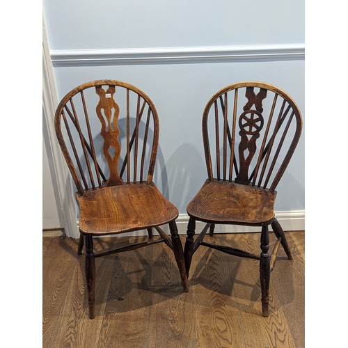 359 - A harlequin set of seven antique spindle wheelback elm windsor Chairs, with moulded saddle seats rai... 