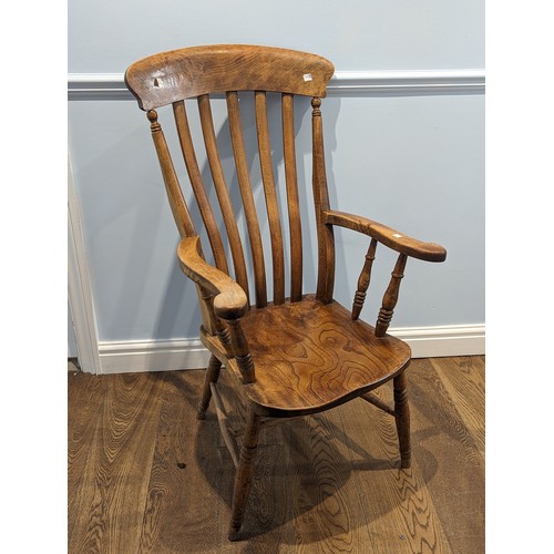 360 - An antique lathe-back ash and elm Windsor Chair, shaped headrest above scroll arms, saddle seat rais... 