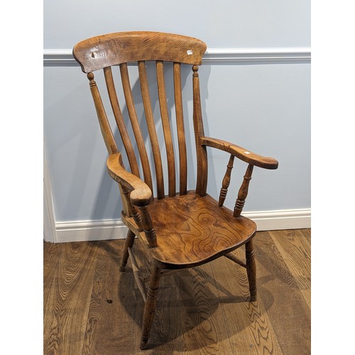 360 - An antique lathe-back ash and elm Windsor Chair, shaped headrest above scroll arms, saddle seat rais... 