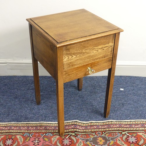 515 - An antique oak hinged top work Table, of a small size, W 38 cm x H 61 cm x D 38 cm.