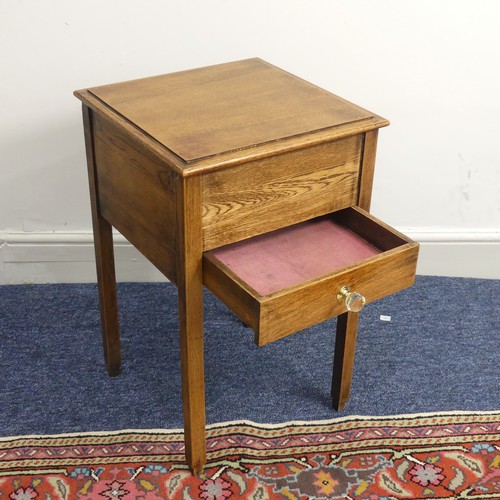 515 - An antique oak hinged top work Table, of a small size, W 38 cm x H 61 cm x D 38 cm.