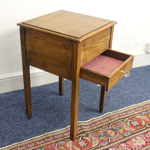 515 - An antique oak hinged top work Table, of a small size, W 38 cm x H 61 cm x D 38 cm.