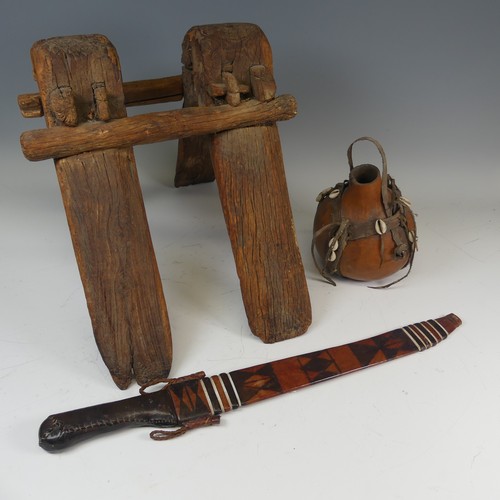 523 - An antique tribal wooden camel Saddle, W 34 cm x H 35 cm x D 46 cm, together with a West African Mac... 