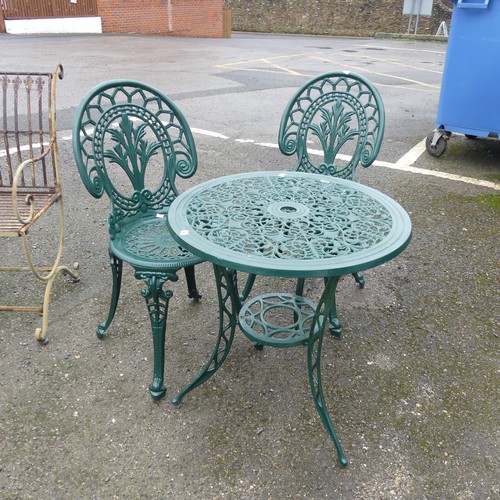 653 - A green-painted cast metal circular garden Table and two Chairs, with pierced design, (Table) W 61 c... 