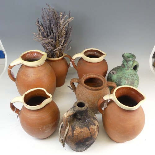 134 - A matched set of four graduated pottery Jugs, with cream glazed rims, the tallest H 29cm, together w... 