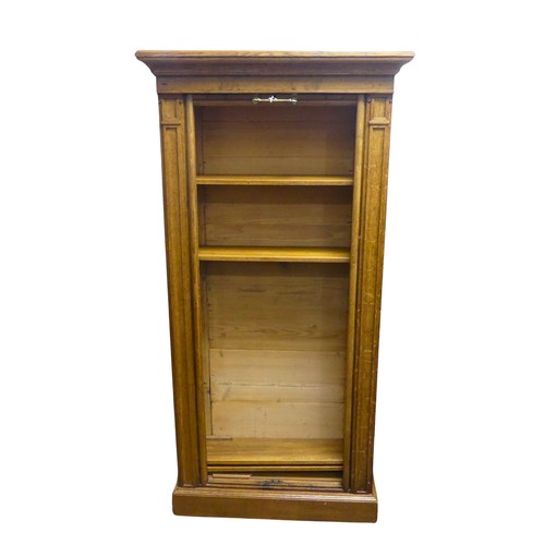 363 - A late 20th century tambour front Cabinet / Shelves, moulded cornice above Wellington chest style fr... 