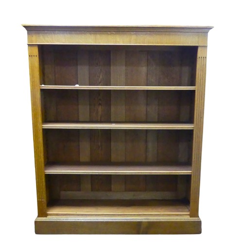 362 - An Edwardian light oak open Bookcase, with four adjustable shelves flanked by pilasters on plinth ba... 