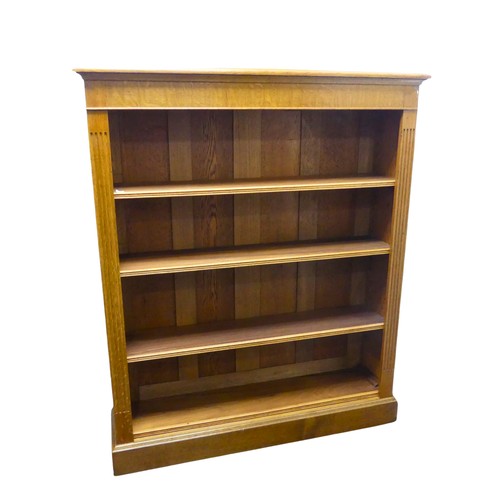 362 - An Edwardian light oak open Bookcase, with four adjustable shelves flanked by pilasters on plinth ba... 