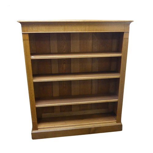 362 - An Edwardian light oak open Bookcase, with four adjustable shelves flanked by pilasters on plinth ba... 