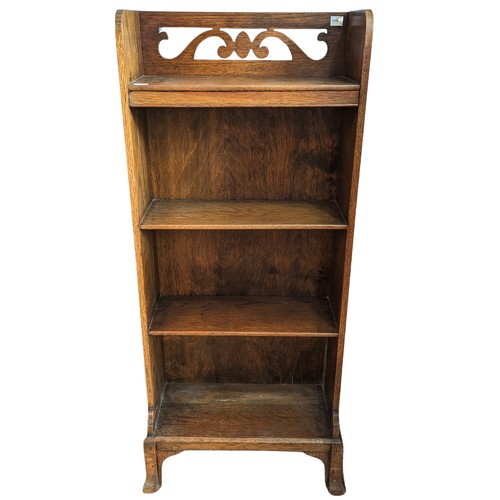 385 - An unusual Arts and Crafts oak open Bookcase, gallery pierced with stylised scrolls raised on four f... 