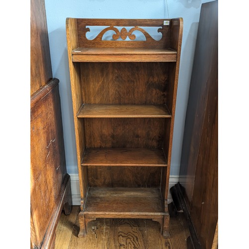 385 - An unusual Arts and Crafts oak open Bookcase, gallery pierced with stylised scrolls raised on four f... 