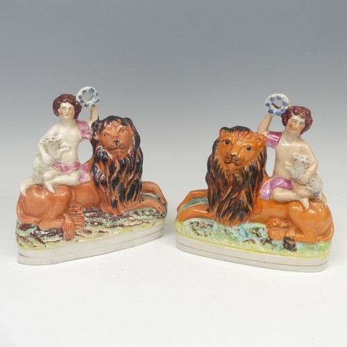 142 - A matched pair of 19thC Staffordshire pottery figural Bookends, modelled as a recumbent lion with a ... 