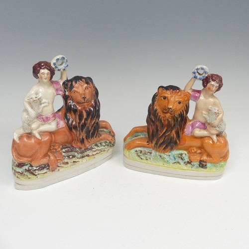 142 - A matched pair of 19thC Staffordshire pottery figural Bookends, modelled as a recumbent lion with a ... 